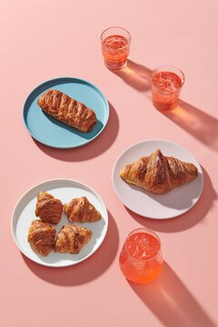Soft drinks and tasty crusty croissants on the plate  in coffee shop