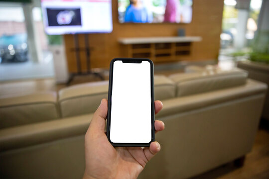 A close-up image of a man using his smartphone. smartphone white-screen mockup for displaying your graphic banner.