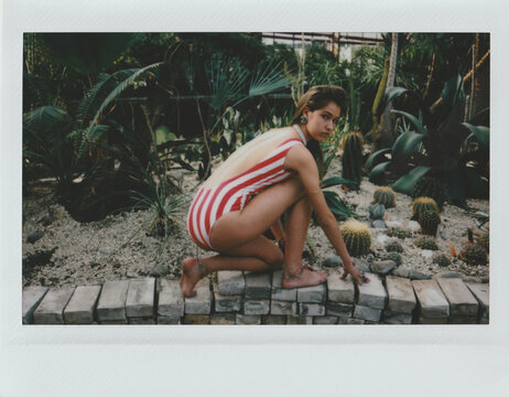  Polaroid of young fashionable girl in greenhose