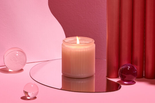 Burning soy candles on empty showcase for cosmetic