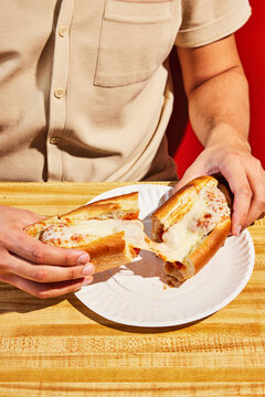 Anonymous Man Pulls Apart Melted Cheese And Bread