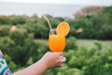 A Plus size woman drinks a freshly and delicious squeezed