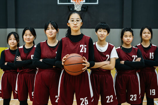 Portrait of basketball girls team in a gym