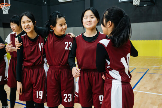 Portrait of basketball girls laughing in a gym