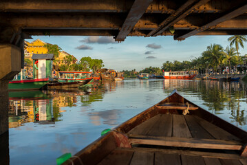 Boat under the bridge on Thu Bon River, Hoi An, Vietnam