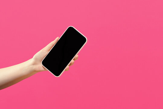 Woman's hand presenting modern smartphone with blank screen