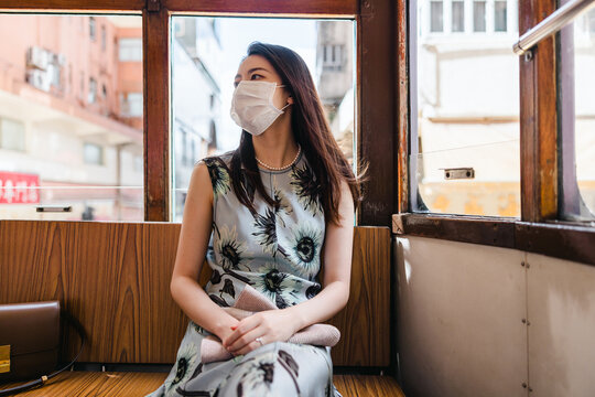 A woman sitting in a Ding Ding tram