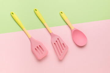 Silicone set of kitchen blades on a two-tone background.