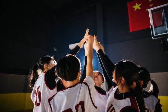 Basketball team high fiving in gym