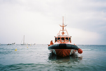 Orange rescue coast guard patrol boat on the sea on a cloudy day
