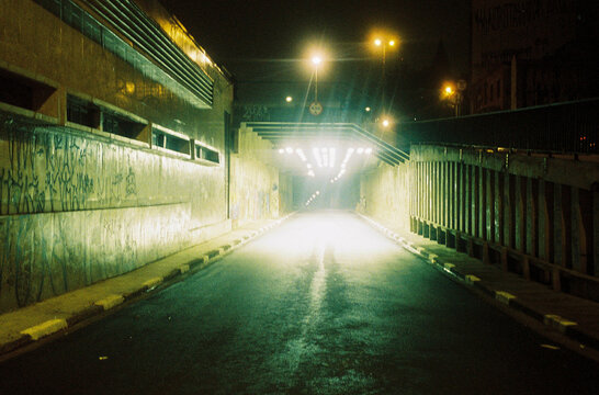 Fototapeta View from the car: dark tunnel at night, scary urban scenario
