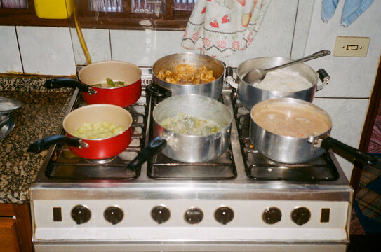 Vintage photo of pans on stove cooking complete Brazilian meal