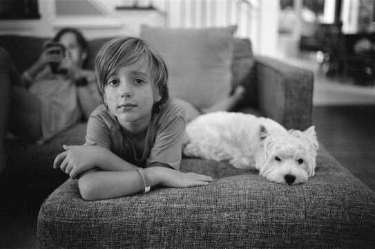Cute white dog and a young boy 