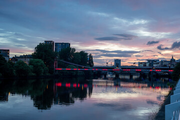 Experience the poetic allure of twilight with this enchanting photo featuring a bridge adorned with...
