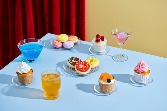 Colorful and fresh breakfast with sweet, croissants and soda glasses