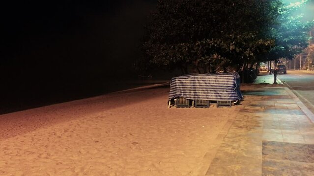 April 5, 2022 - Jomtien Beach, Chonburi, Thailand. Walking along a dark and dimly lit promenade in the early hours of the morning before the sunrise.