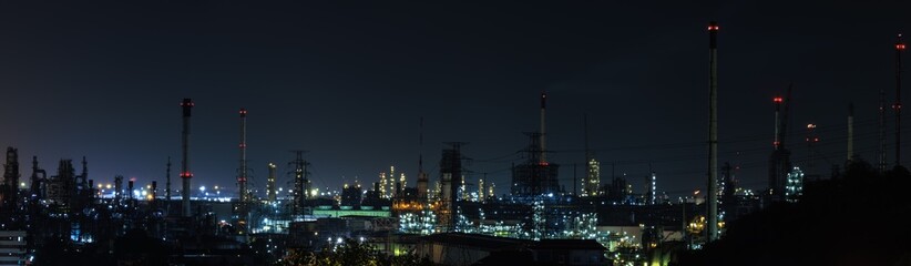 Naklejka premium Panorama night cityscape and oil refinery, petroleum oil yard, tank storage field. Nice lighting cover the city. Business and industrail, import and export, international transportation.