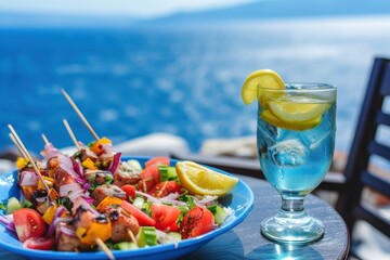 Vegetable salad and souvlaki on skewers in front of the sparkling blue sea during summer