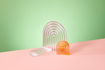 Transparent ribbed plate arches  amber and pink on a green and pink