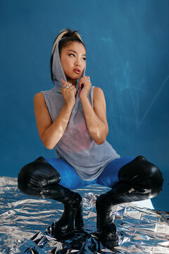 Asian woman sitting on haunches
