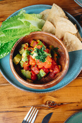 A bowl of food with a green leaf on top