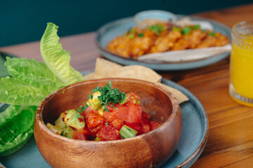 A bowl of food with a green leaf on top of it