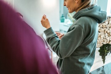 Crop woman standing in studio
