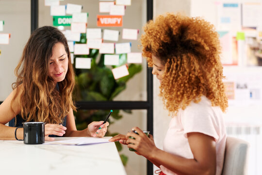 Colleagues discuss job candidate resume.