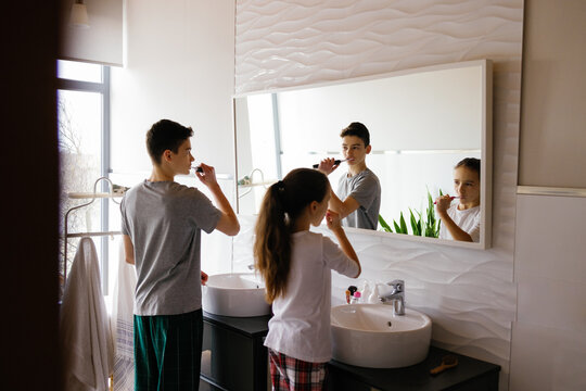 Siblings maintaining oral health healthcare routine