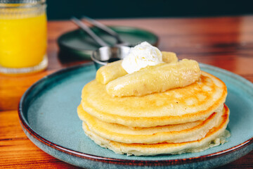 A stack of pancakes with bananas on top of them