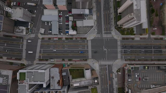 Road Grid In Metropolis. Top Down View Of Cars Passing Through Crossroads. Streets And Buildings In City. Osaka, Japan