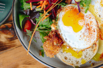 A plate of food with a fried egg and a side of vegetables