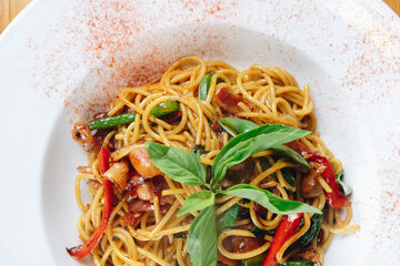A plate of noodles with vegetables and meat