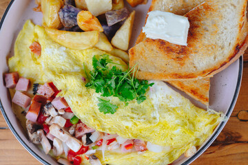 A plate of food with a fried egg, potatoes, and toast