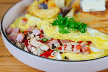A plate of food with a variety of ingredients including ham, mushrooms