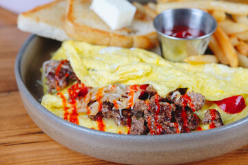 A plate of food with a fried egg, bacon, and cheese