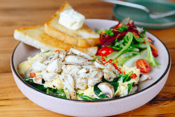 A plate of food with a salad and toast