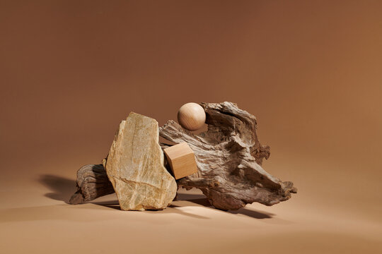 Stone pebble podium and weathered driftwood.