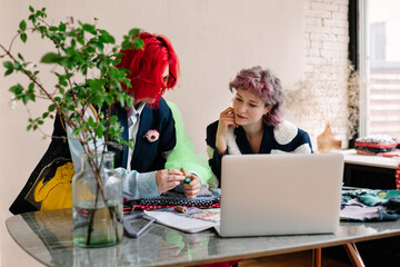 Focused woman clothing designers discussing design
