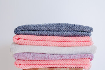 Pile of pink and purple towels. Nice bathroom interior details for girls