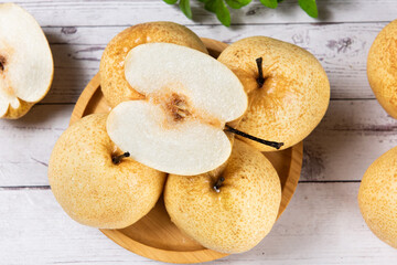 fresh Asian pear fruit and half sliced on wooden table.