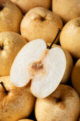 closeup of Asian pear fruit and half sliced background.
