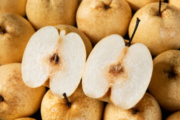 closeup of Asian pear fruit and half sliced background.