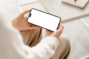 A mobile phone with a white screen in women's hands