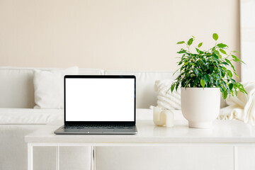 Laptop with a white screen in the home interior
