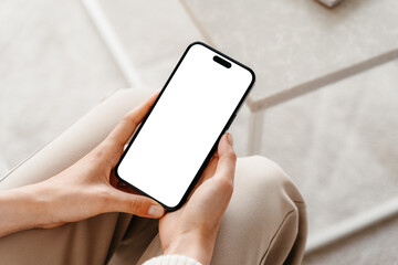 A mobile phone with a white screen in women's hands