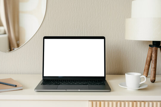Laptop with a white screen in the home interior