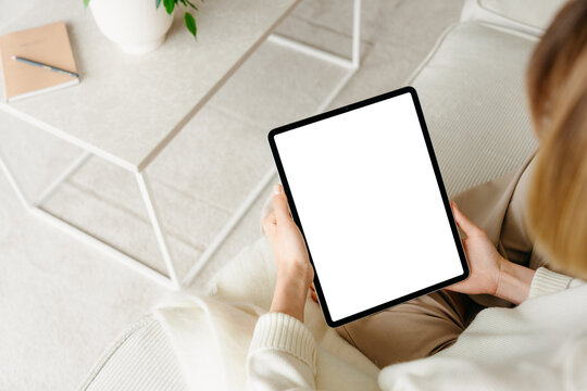 A tablet with a white screen in women's hands