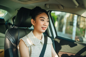 A young woman is driving a car