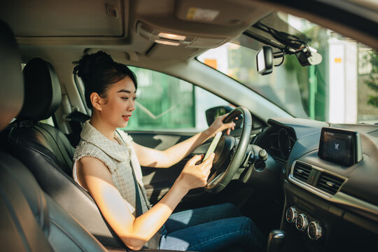 woman texting while driving a car
